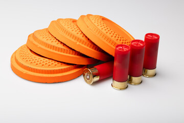 Clay shooting targets with shotgun shell bullets on white background © Suttiwan