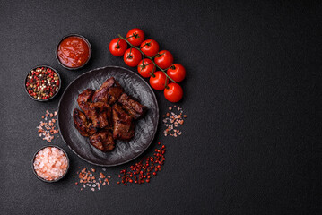 Beef, grilled meat in pieces, or kebab with sauce and vegetables. Beef in pieces