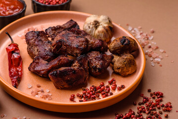 Beef, grilled meat in pieces, or kebab with sauce and vegetables. Beef in pieces