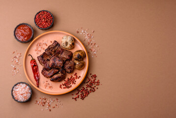 Beef, grilled meat in pieces, or kebab with sauce and vegetables. Beef in pieces