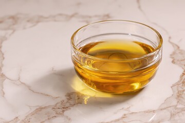 Glass Bowl Containing Natural Oil on Marble Surface Decor