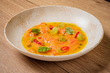 Salmon fillet in a vibrant sauce with grapes and herbs invites flavor exploration