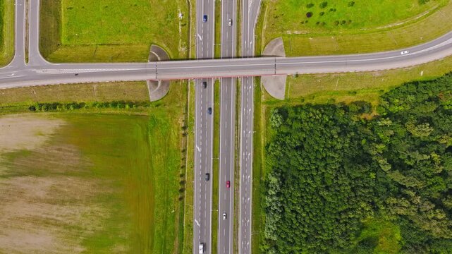 Cinematic ascending drone view of highway bridge, traffic roads, Paslek Poland