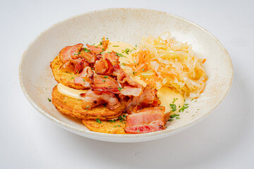 Golden potato pancakes topped with crispy bacon and sauerkraut make a hearty breakfast delight