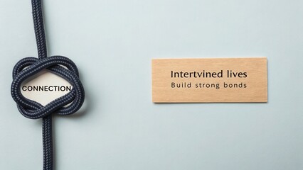 Intricate dark rope knot and wooden sign with intertwined lives message