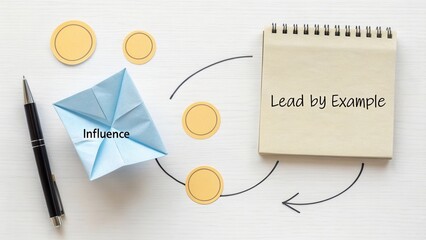 Influence and Leadership Concept with Paper Origami and Notebook on Light Background for Motivational Themes