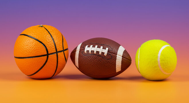 Three sports balls are arranged in a row, including a basketball, football, and tennis ball.