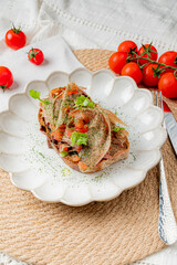 Tasty meal features layers of ingredients on a decorative plate, garnished with fresh herbs