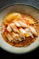 Savor the flavors of perfectly grilled fish atop warm, nutty grain with rich sauce