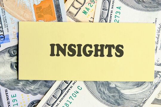 INSIGHTS written on yellow paper on the background of banknotes. Technology and data science concept.
