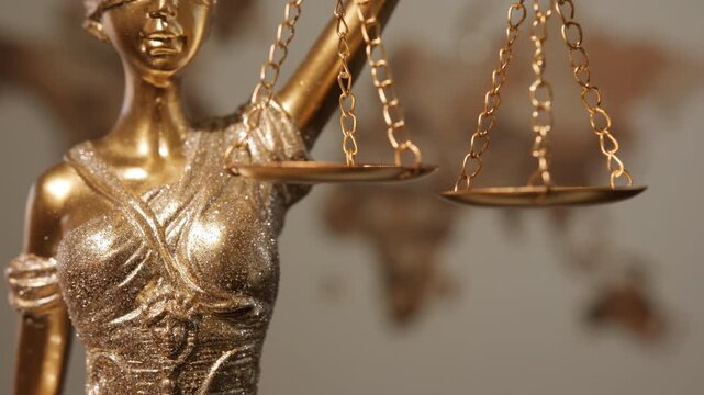 Scales of justice for ratio of good and evil deeds at statue of goddess of justice close-up