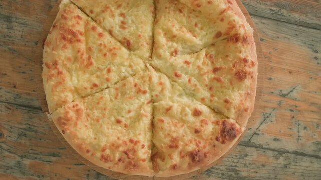 Khachapuri on wooden rustic table close-up top view. Georgian food, Caucasian cuisine.