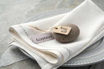Serene Table Setting with a Smooth Stone, Acceptance Tag, and Calm Atmosphere for Mindfulness and Reflection