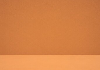 An empty product stage featuring a rough terracotta wall above a textured, sandy floor in a monochromatic orange setting
