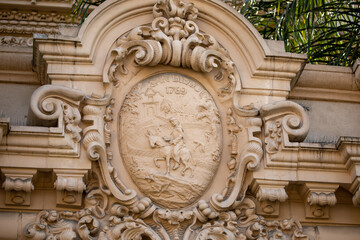 The medallion adorning the top of the arch on one of the  historic buildings in Balboa Park in San Diego, Ca.