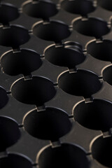 Obraz premium a black plastic tray for growing a large number of seedlings of agricultural or other plants before planting them in a field or garden