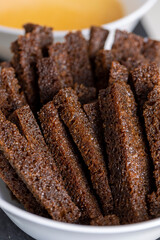 fried bread pieces until crisp in sunflower oil with spices, delicious crispy rye bread croutons for cheese sauce, close up