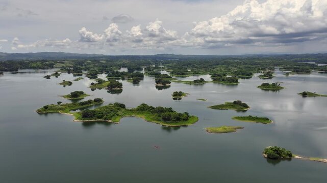 4k aerial video footage, flying across Bayano Lake - with many small islands, green Jungle and Rainforest landscape all around - located near Akua Yala in Babita de Perro, Panama 