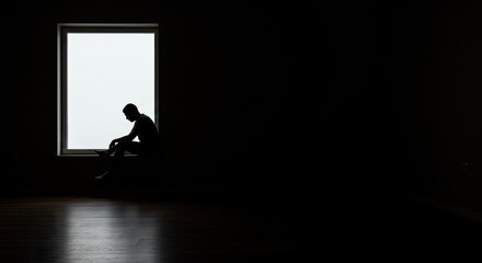 Solitary figure silhouetted against a bright window contemplating life's challenges in quiet contemplation, conveying a sense of introspection and thoughtful reflection