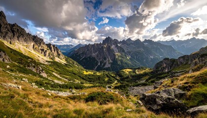 Fototapeta premium Turquoise Alpine Lake Surrounded by Green Hills Under Cloudy Sky Landscape Panoramic View