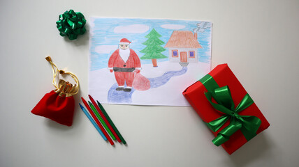 Colorful Christmas drawing with Santa Claus, a house, and a tree surrounded by holiday gift bags, pencils, and a wrapped present, perfect for festive and holiday season designs. Childrens drawing.