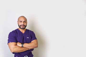Male professional standing with arms crossed, confidence and expertise in healthcare uniform