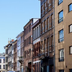 Old townhouses lining a city street with traditional brick facades and architecture. Antwerp, Belgium