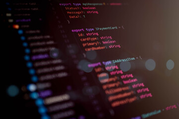 Close-up macro shot of TypeScript source code interface structure on a dark theme editor for software development, programming, and IT engineering projects.