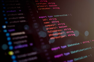Close-up view of programming code on a computer screen showing TypeScript interface structure for web development and software engineering projects.