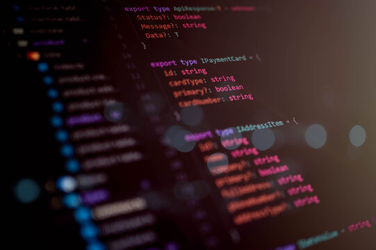 Close-up macro shot of TypeScript source code interface structure on a dark theme editor for software development, programming, and IT engineering projects.