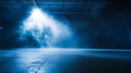 Obraz premium Moody warehouse interior with smoky atmosphere and dramatic spotlight casting a beam on floor