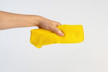 Yellow fiber cleaning cloth, new cloth ready to use on hand, white background