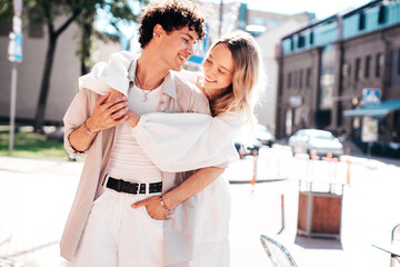 Smiling beautiful woman and her handsome boyfriend. Woman in casual summer clothes. Happy cheerful family. Female having fun. Couple posing in the street it sunny day. Cheerful and happy
