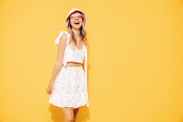 Young beautiful smiling blond female in trendy summer  white top and skirt clothes. Carefree woman...