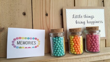 Colorful jars of candy with a nostalgic card on wood background showcasing the beauty of simple moments and joyful memories