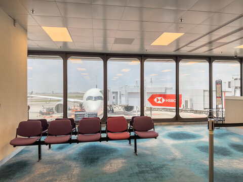View of departure gate with hsbc logo and aircraft at singapore airport