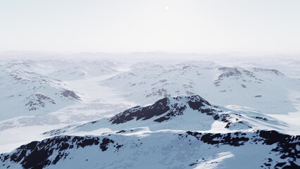 Vast mountain range blanketed in snow extends across the horizon, glistening under the bright sun. The serene landscape evokes a sense of peace and majesty in natures beauty.