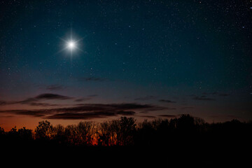 Fototapeta na wymiar a Christmas star shines at night over the mountains of Bethlehem