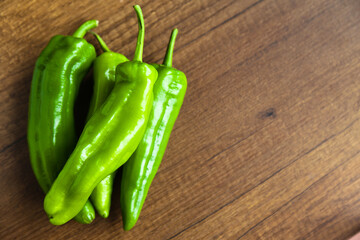 Fresh, tasty organic vegetables, green pepper, isolated on brown wood cutting board