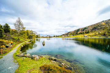 Fototapeta premium View of Lake Falkert in the Gurktal Alps and the surrounding landscape. Nature at a mountain lake in Carinthia. High mountain lake in Austria. 