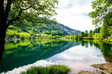 Landscape at Lake Feldsee in Carinthia. Nature at an idyllic lake in Austria with mountains in the background.

