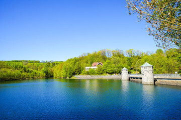 Obraz premium View of the Fürwigge Dam and the surrounding landscape. Nature at the lake near Meinerzhagen and Lüdenscheid. 