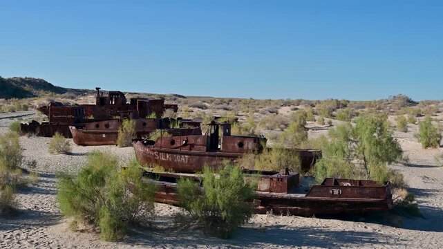 Old rusting fishing vessels where the Aral Sea used to be in the Moynaq ship graveyard in Uzbekistan