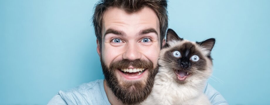The joyful man happily poses with his adorable fluffy cat. - Powered by Adobe