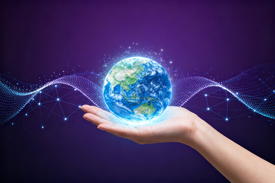 Hand holding glowing earth with digital waves