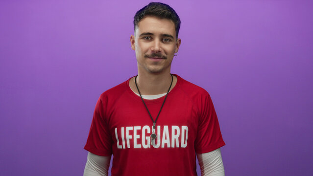Young hispanic man lifeguard in red t-shirt stands confidently against isolated purple background wall - Powered by Adobe
