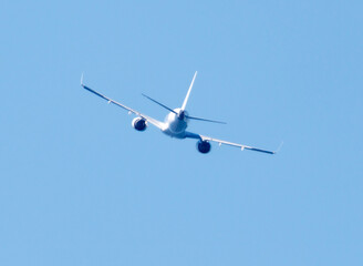 A white airplane is flying in the sky