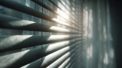Soft morning sunlight beams through horizontal window blinds casting delicate shadows and creating a tranquil indoor atmosphere