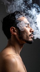 Profile of a man exhaling smoke, eyes closed