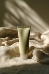 Minimalist Presentation of a Moisturizer Tube on Green Fabric